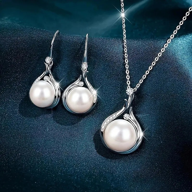 A three piece set of pearl earrings and necklace jewelry