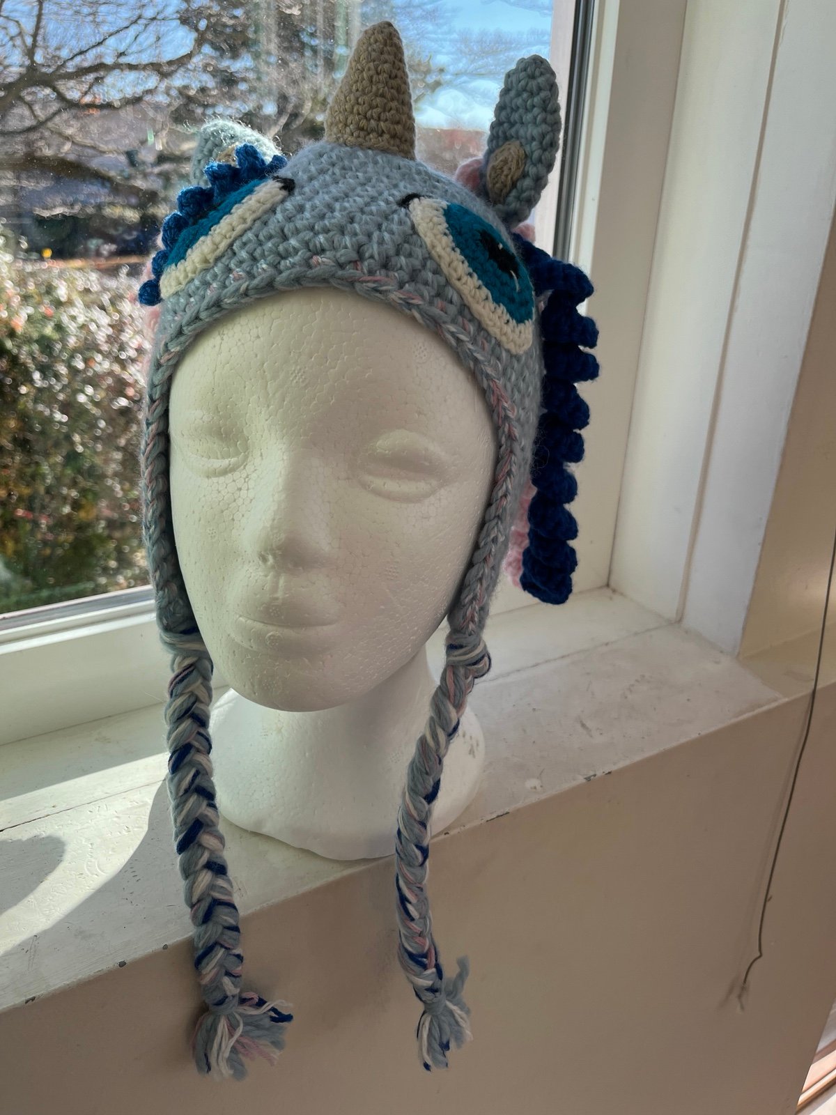 Child hat crocheted with unicorn design