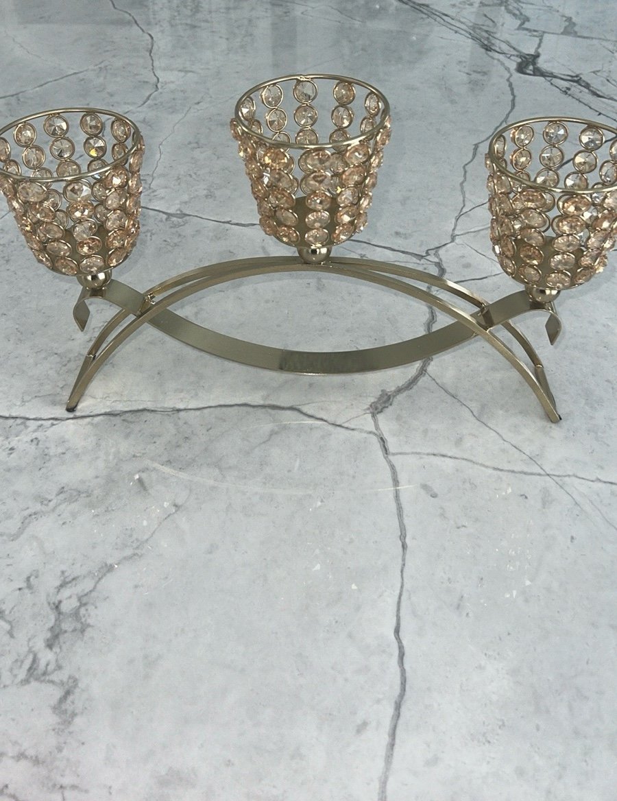 Elegant gold metal like candle holder with beautiful shiny crystal like gems