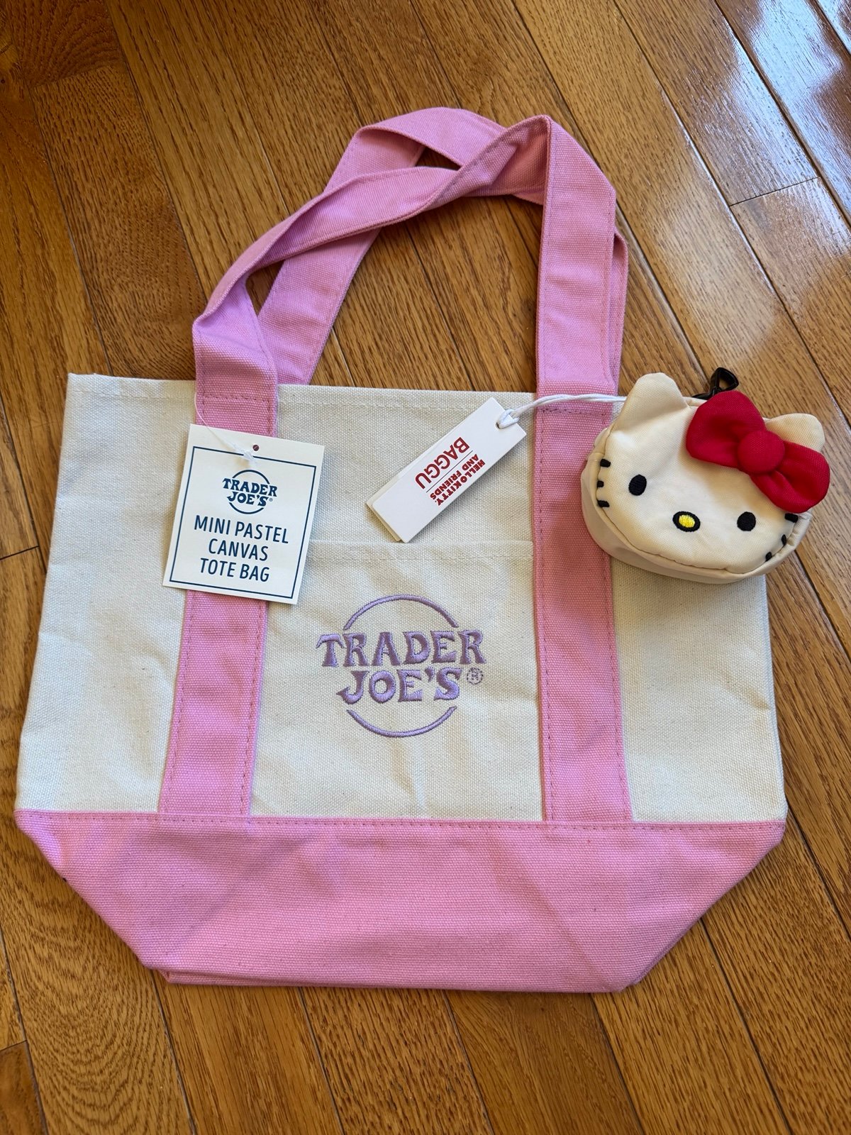 Trader Joe's pink mini tote bag with Baggu Hello Kitty bag charm