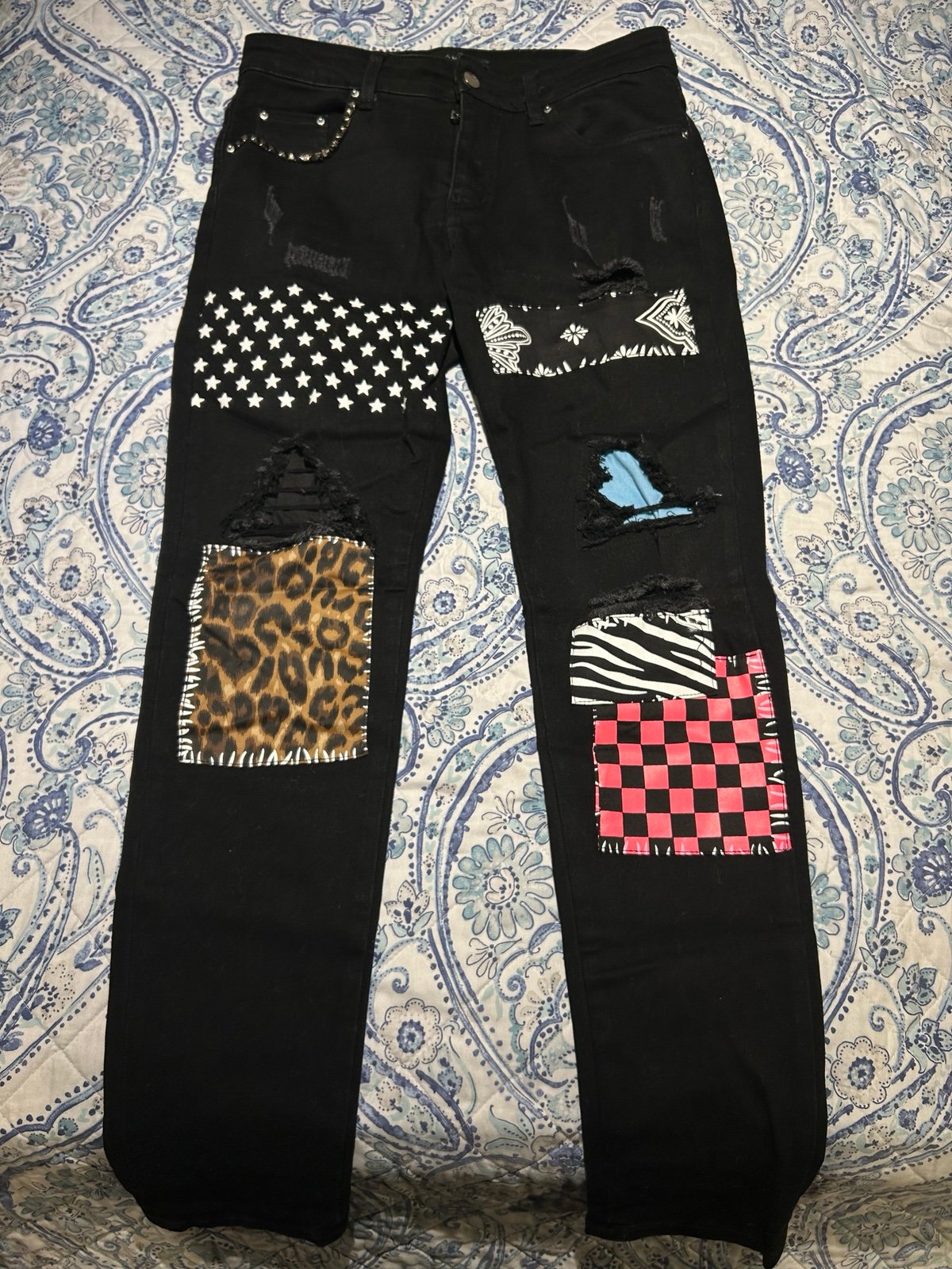 Black Amiri jeans with patches