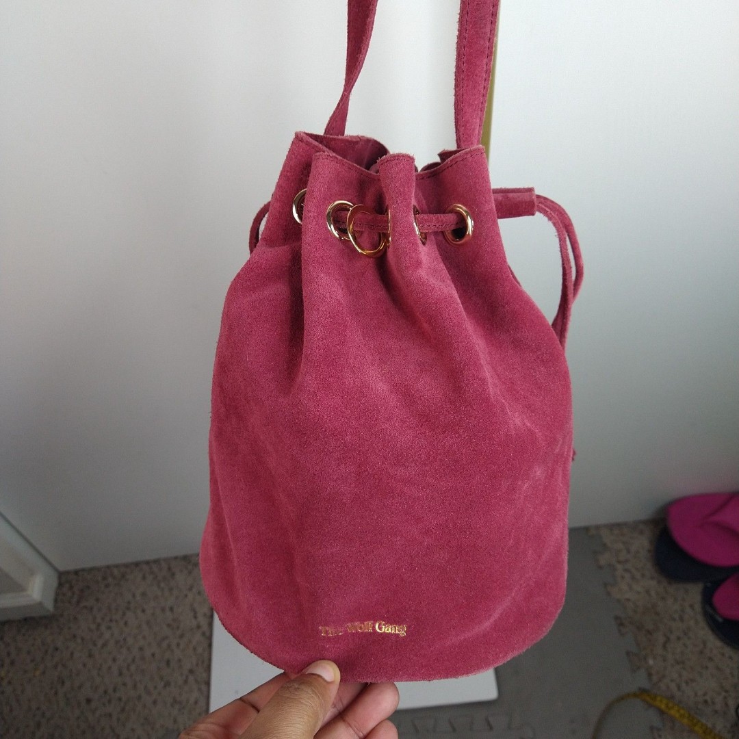The Wolf Gang Tangier Drawstring Crossbody Bucket Bag Pink Suede