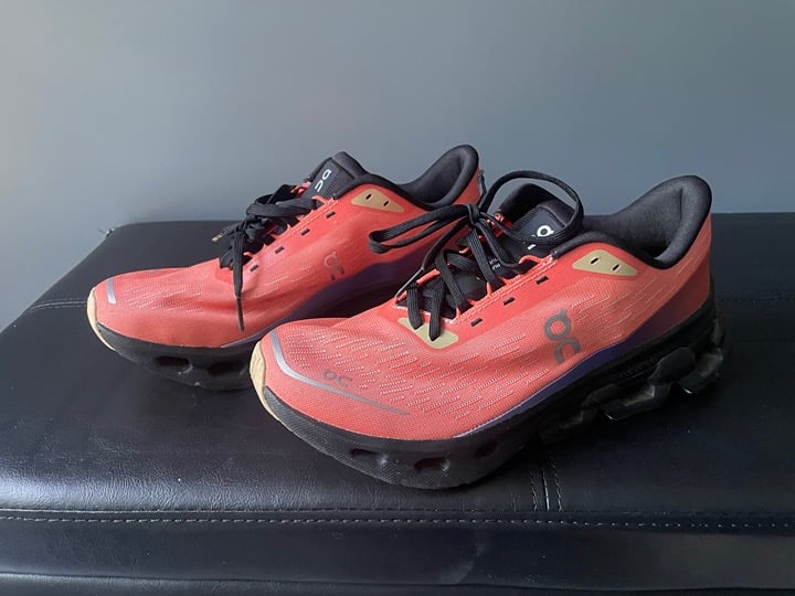 On Running Women and Men’s Athletic Shoes in Orange and Black