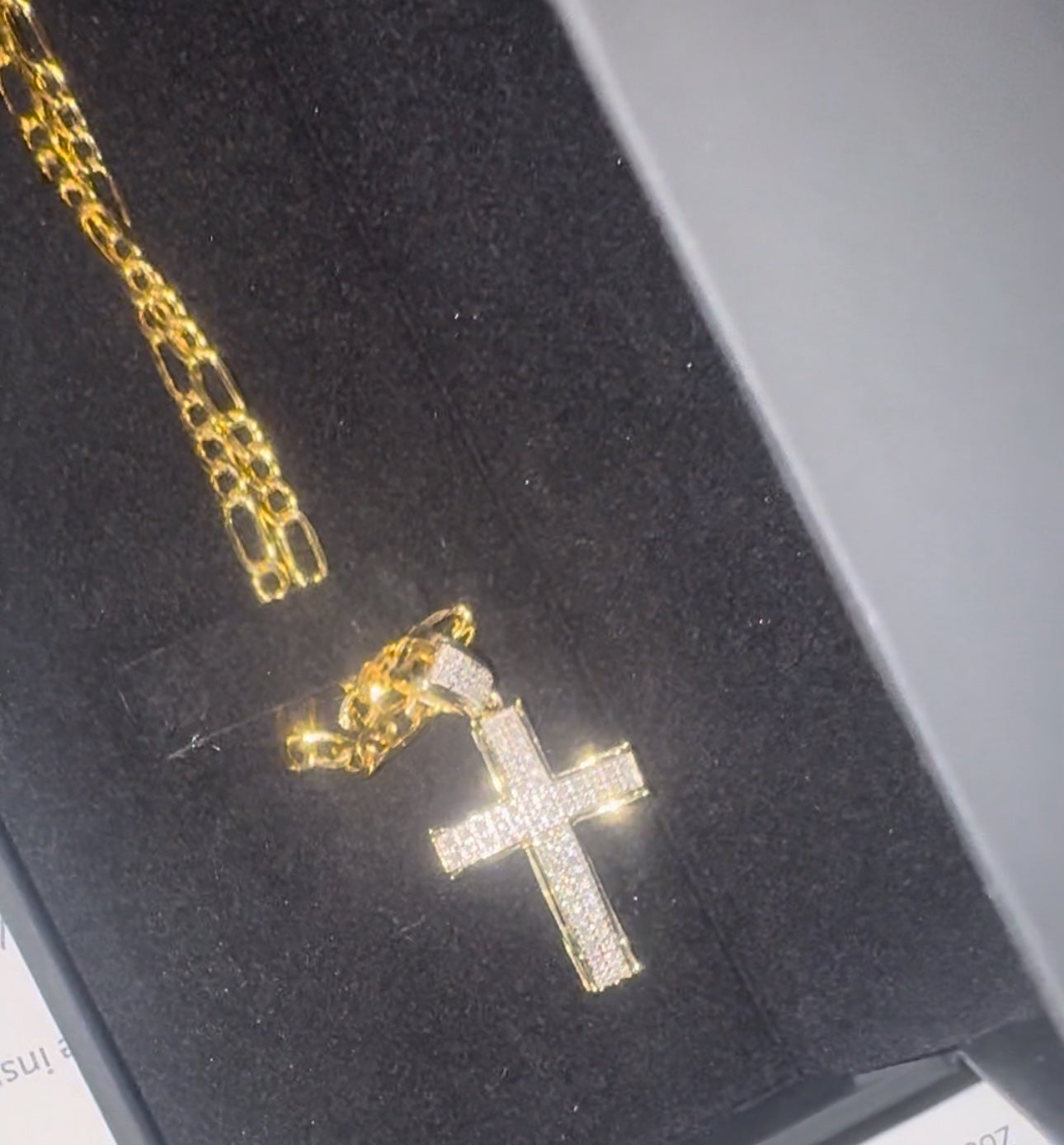 Diamond cross pendant with gold figaro chain 22in 10k