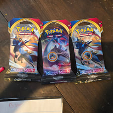 Three sleeved sword and shield booster packs base set