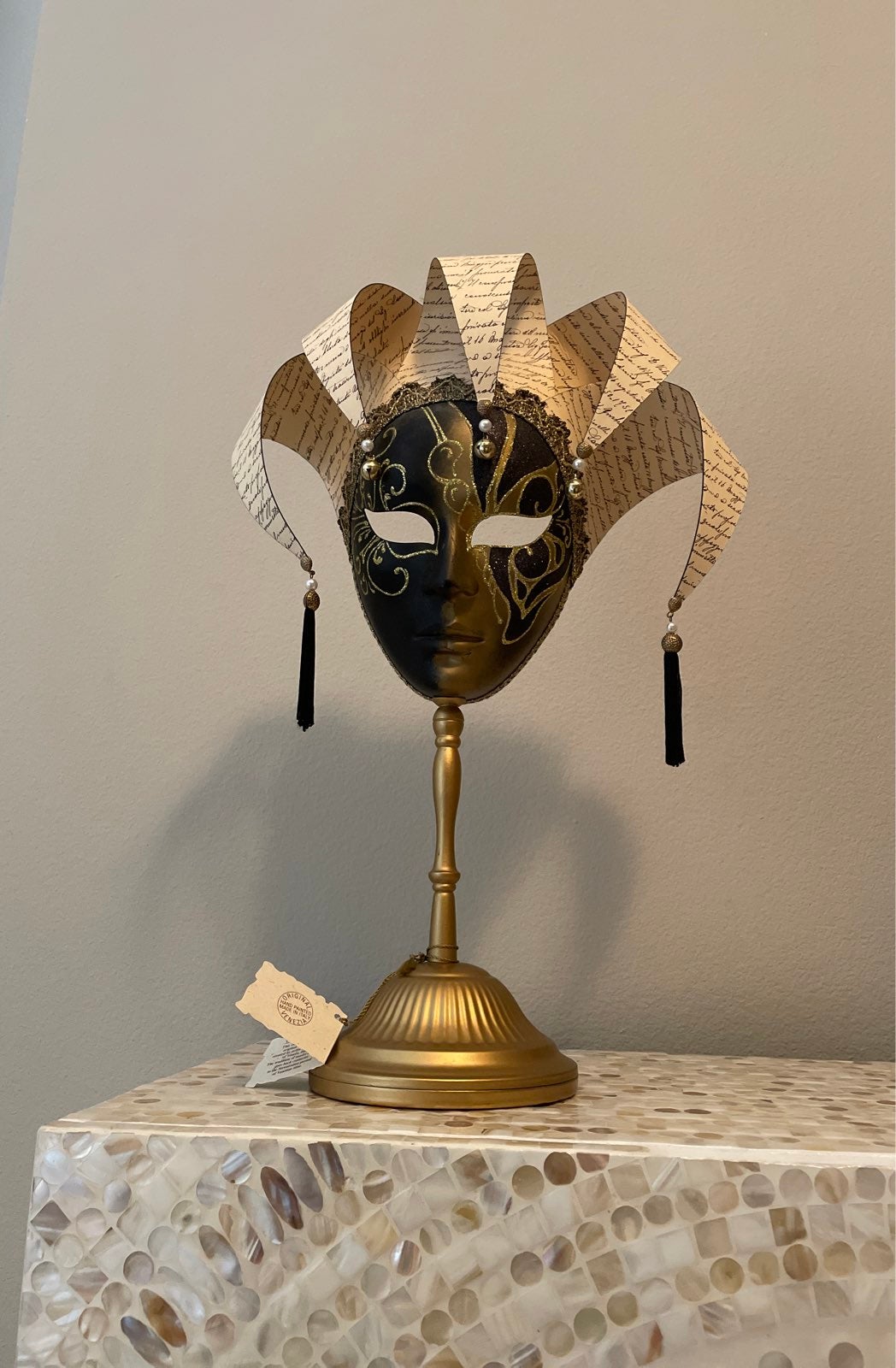 Maschere Veneziane Venetian Mask Black and Gold on a gold stand; can be hung.