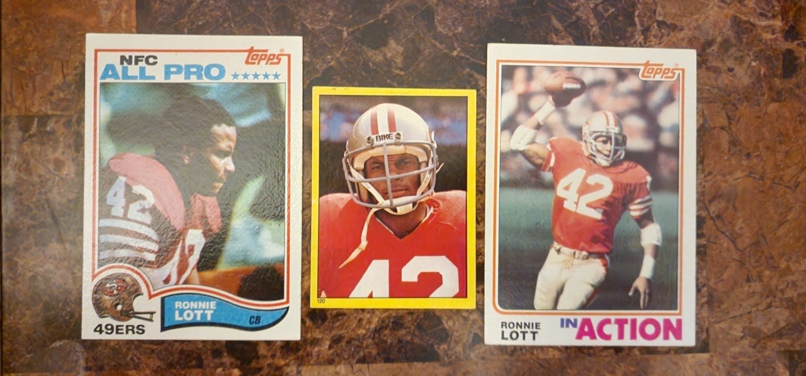 Ronnie Lott 12 pc lot including 1982 Rookie cards and rare sticker, & 2nd year.