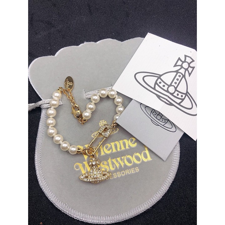 White pearl and gold charm bracelet