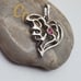 Silver tone melted heart pendant pink crystal detailing