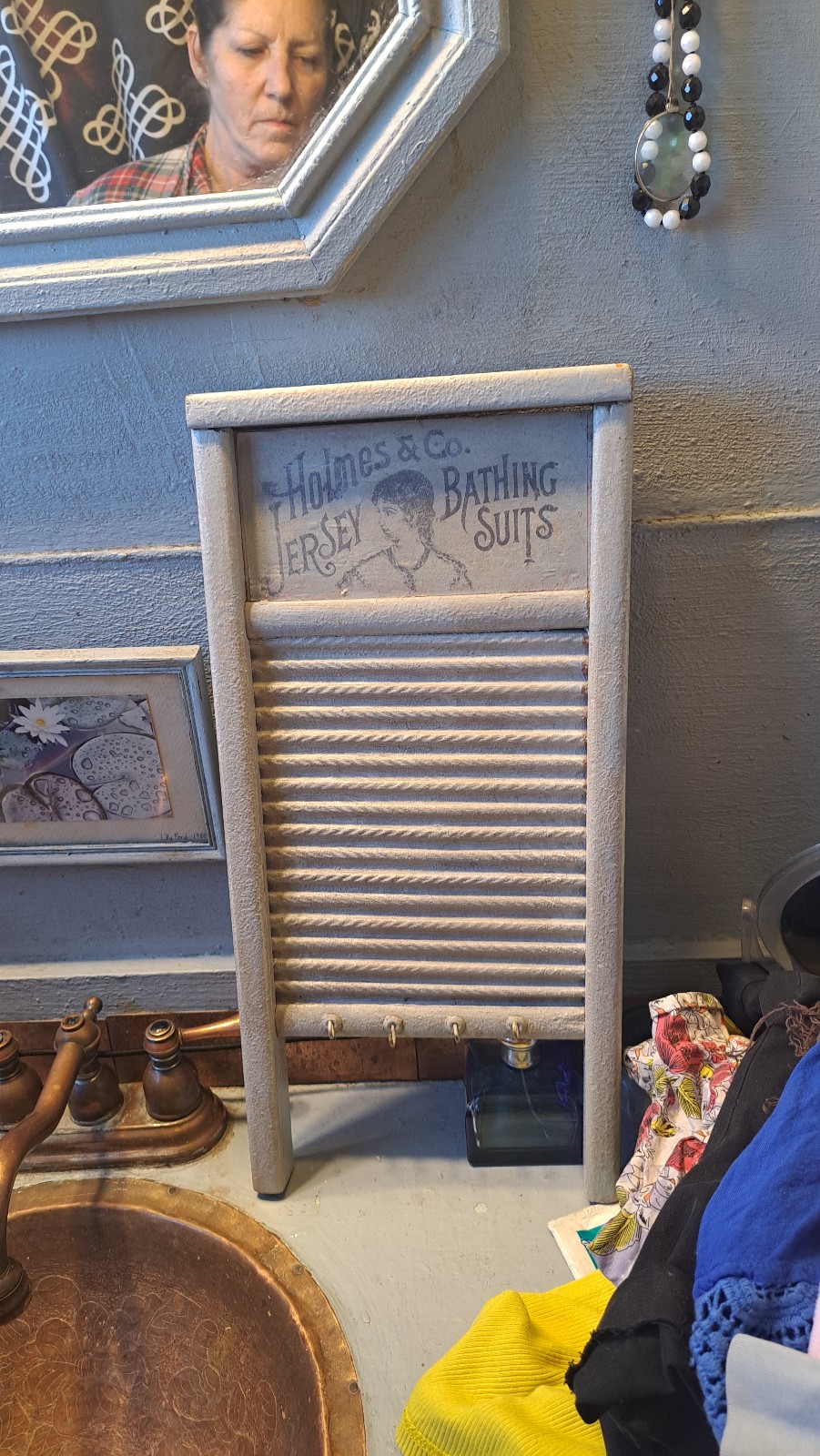 Vintage gray washboard bathing suit logo on front, wood and metal hooks hanging