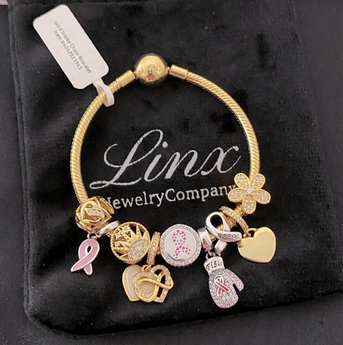 Linx Yellow Gold Snake Chain Bracelet with Breast Cancer Awareness Themed Charms