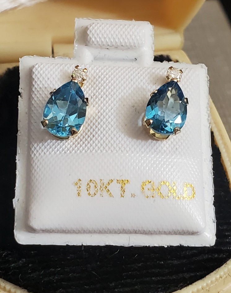 New. 10k blue topaz & moissanite earrings. Tag reads blue topaz total carat weig