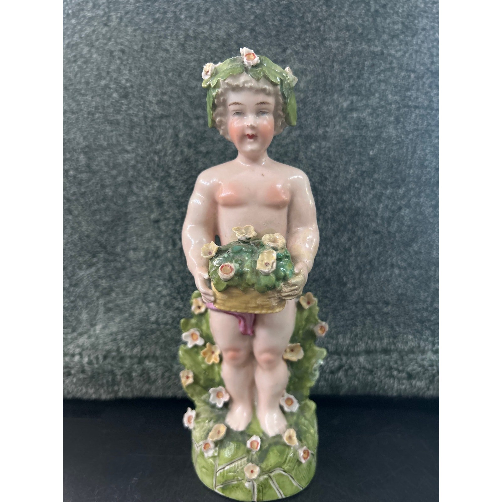 Porcelain Sculpture Putto carrying a floral basket c1780