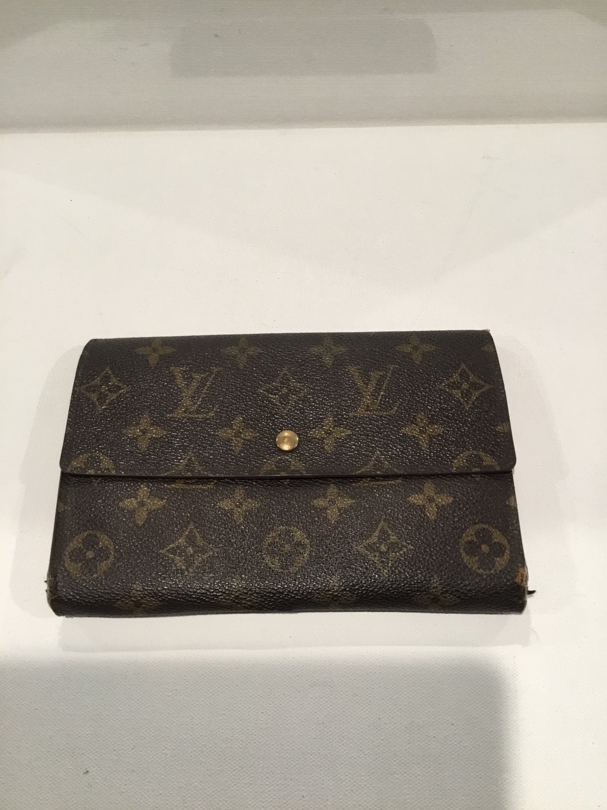 Louis Vuitton Pochette Passport Wallet with bills, coins, passport slots.