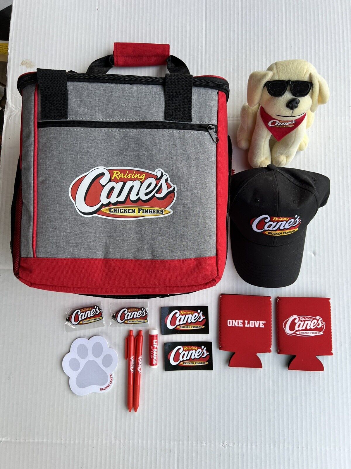 Raising Cane's Chicken Fingers Cooler Bag, Plush Dog, Baseball Cap, Keychain+