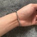 Silver bangle bracelet with rhinestones and screw design. Size 18cm clip on lock