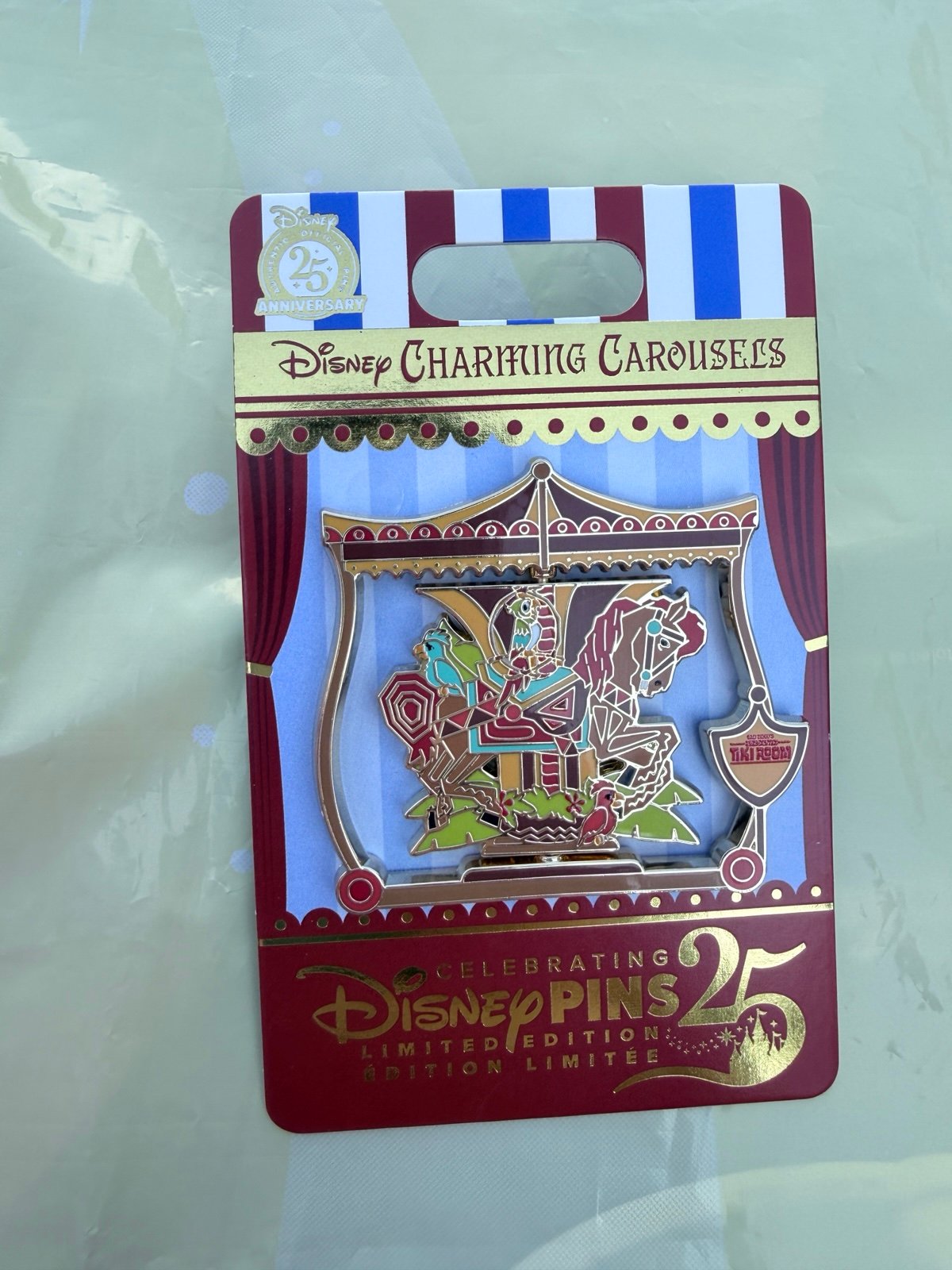 In hand 2025 Disney Parks Charming Carousels Tiki Room LE 2000 Pin