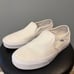 White Slip-On Vans • Women 7.5