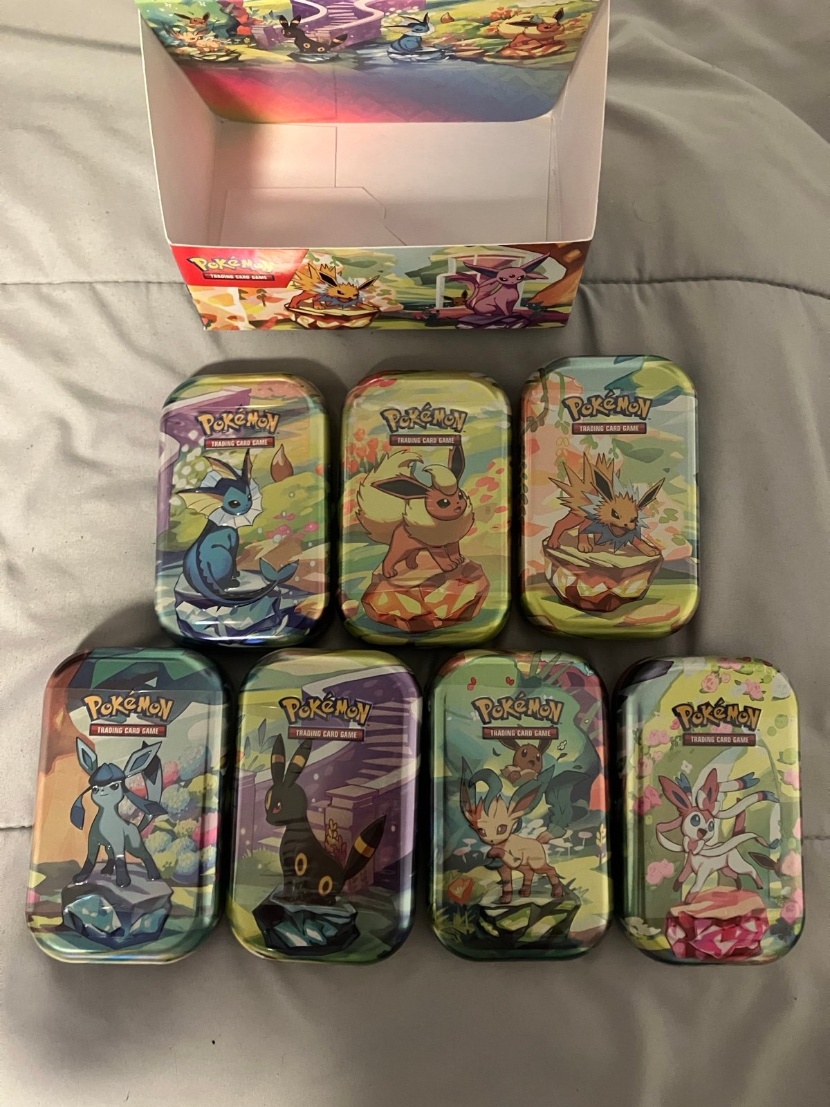 7 Sealed Prismatic Evolutions 2 Pack Mini Tins