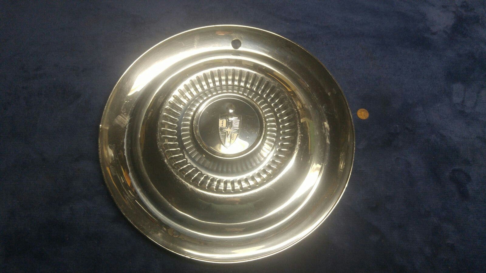 One 1954 Lincoln Capri hubcap