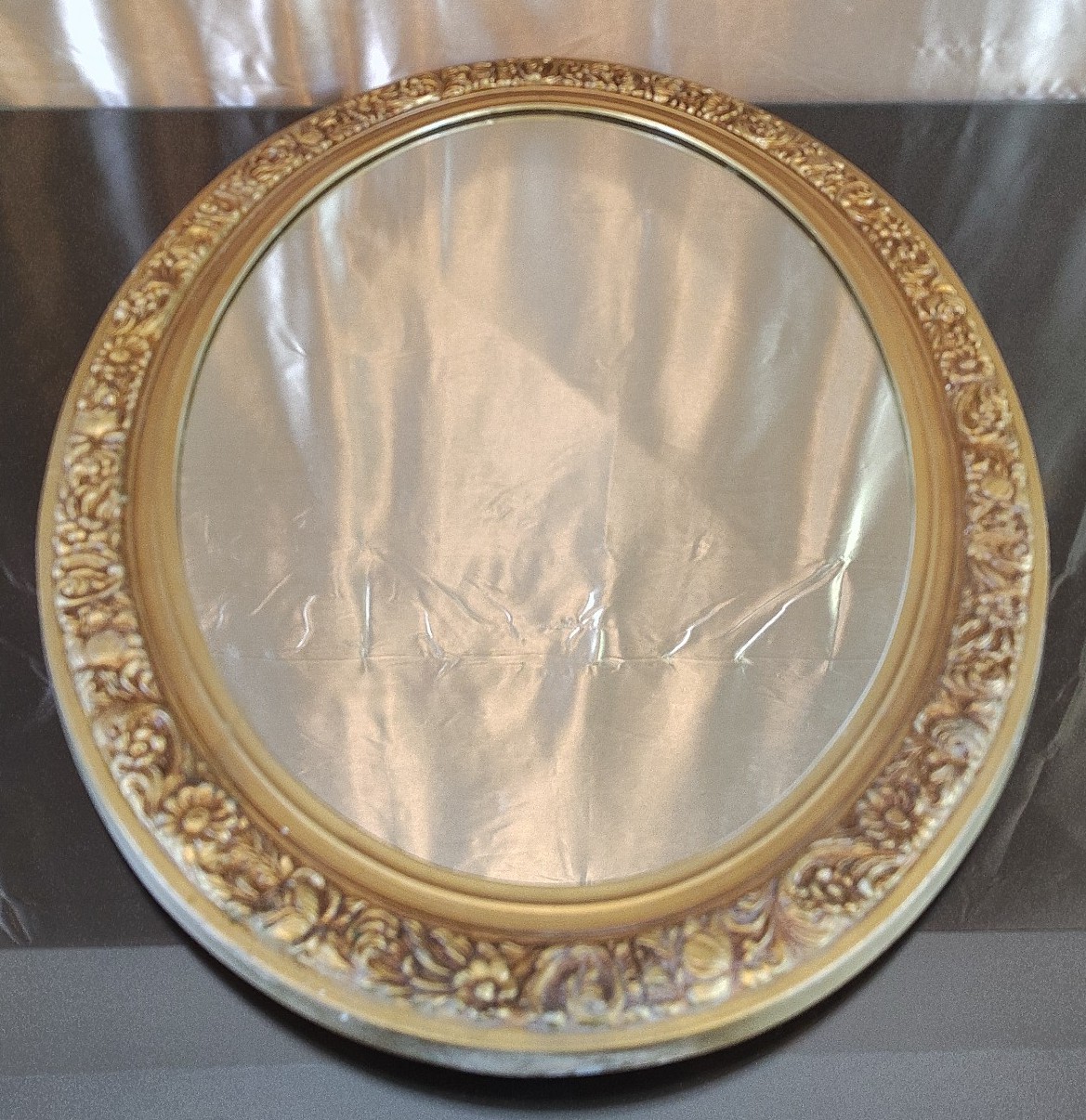 27 and a half by 19 and 3/4 mid-century modern Daisy floral guilt oval mirror