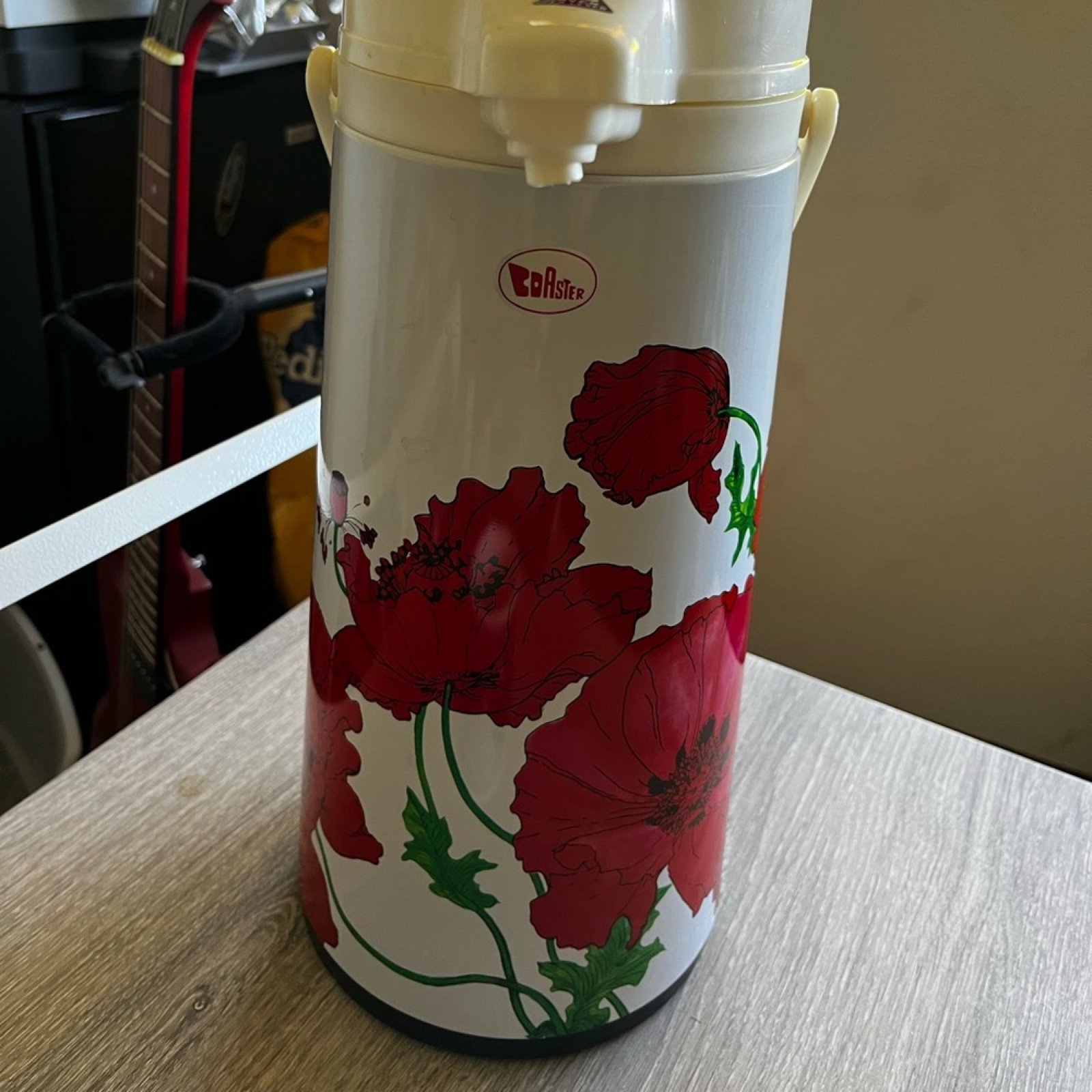Coaster brand coffee dispenser with a poppy pattern