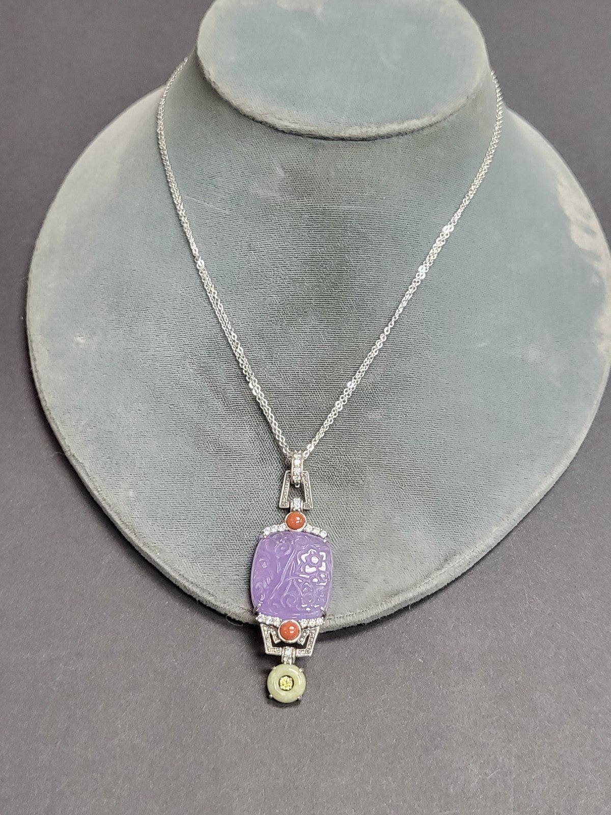 Carved jasper and obsidian bead silver pendant on silver necklace
