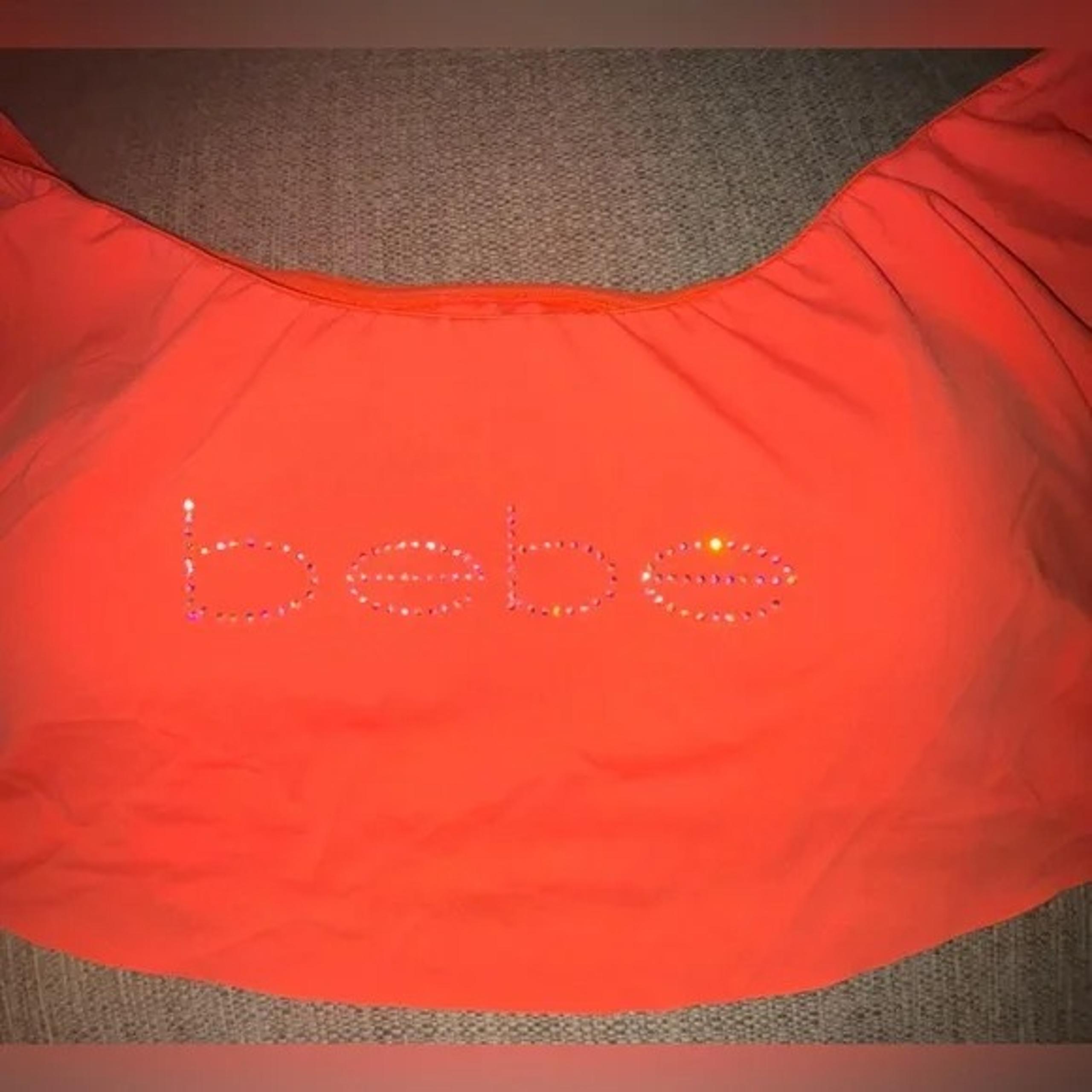 Bebe Rhinestone Logo Ruffle Swim Top in Tangerine Color