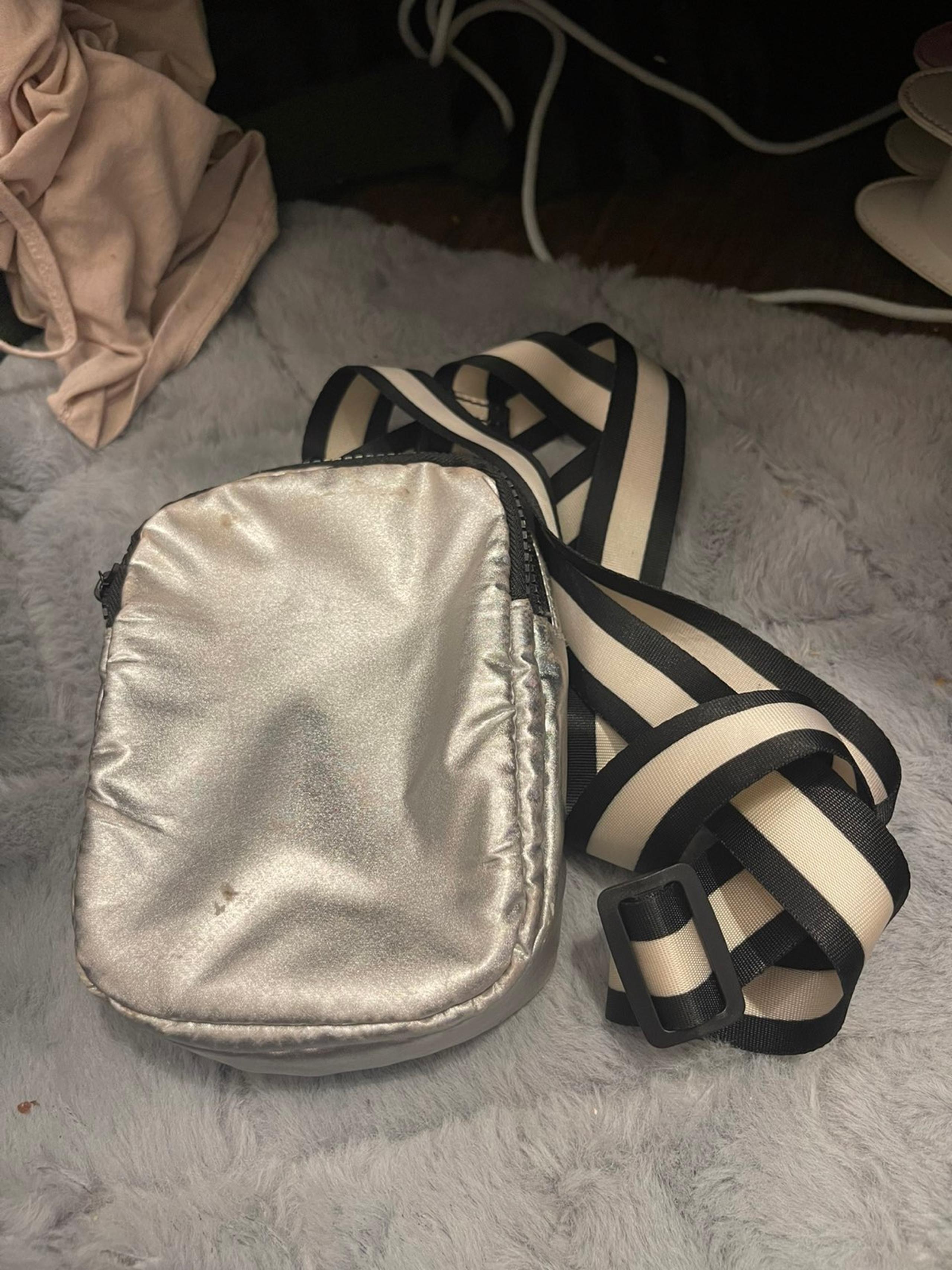 Silver purse with black and white straps