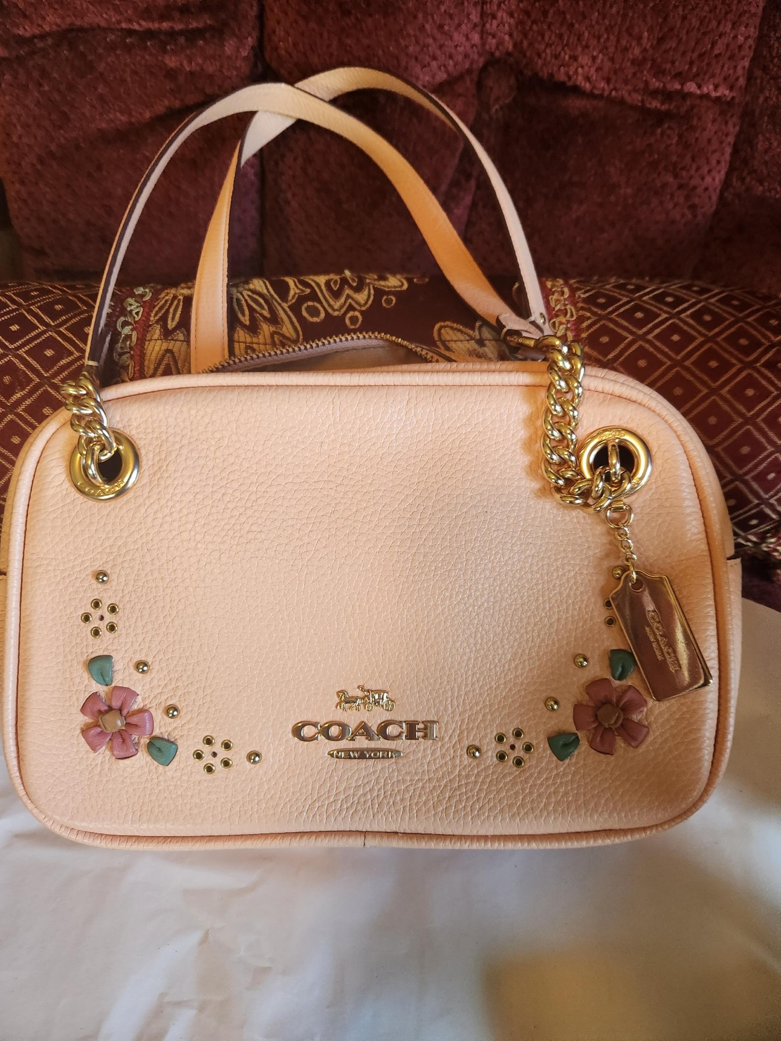 Peach colored Coach purse and wallet