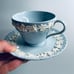WEDGWOOD QUEEN’S WARE cream on lavender embossed teacup & saucer shell edge