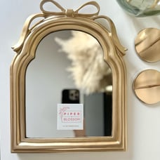 Piper and Blossom gold bow framed mirror
