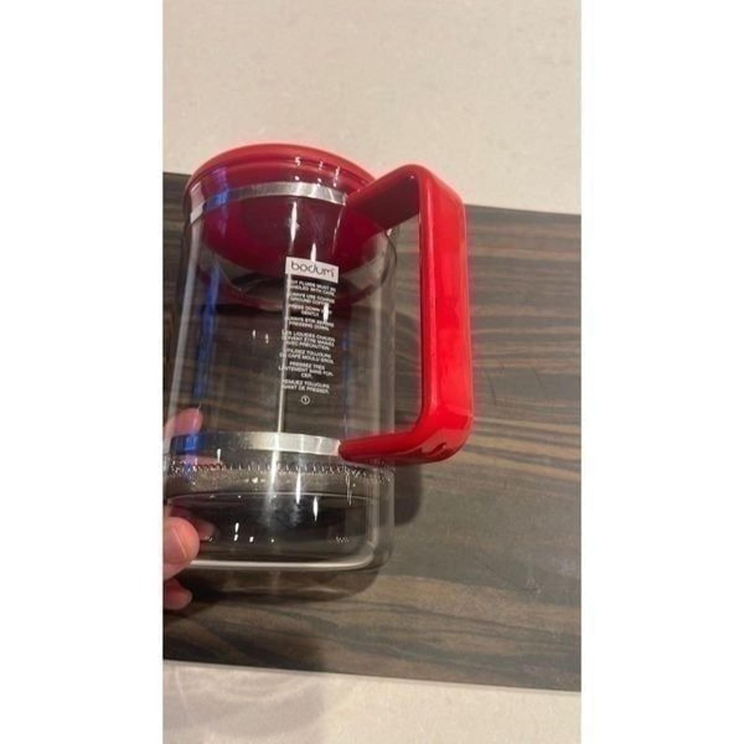 Bodum French press glass crafe  red plastic handle and lid makes great coffee.