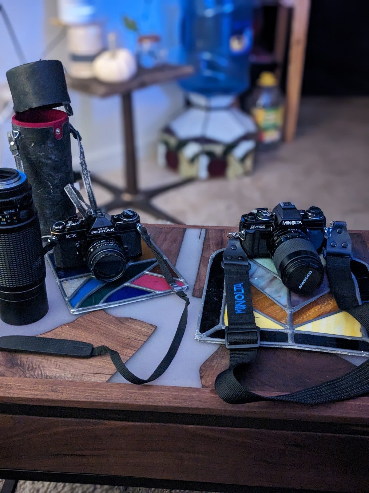 Two separate Camaras with flash. One being a minolta and the other Pentax.