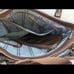 Brown tumi with croc embossed trim