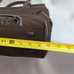 Brown tumi with croc embossed trim