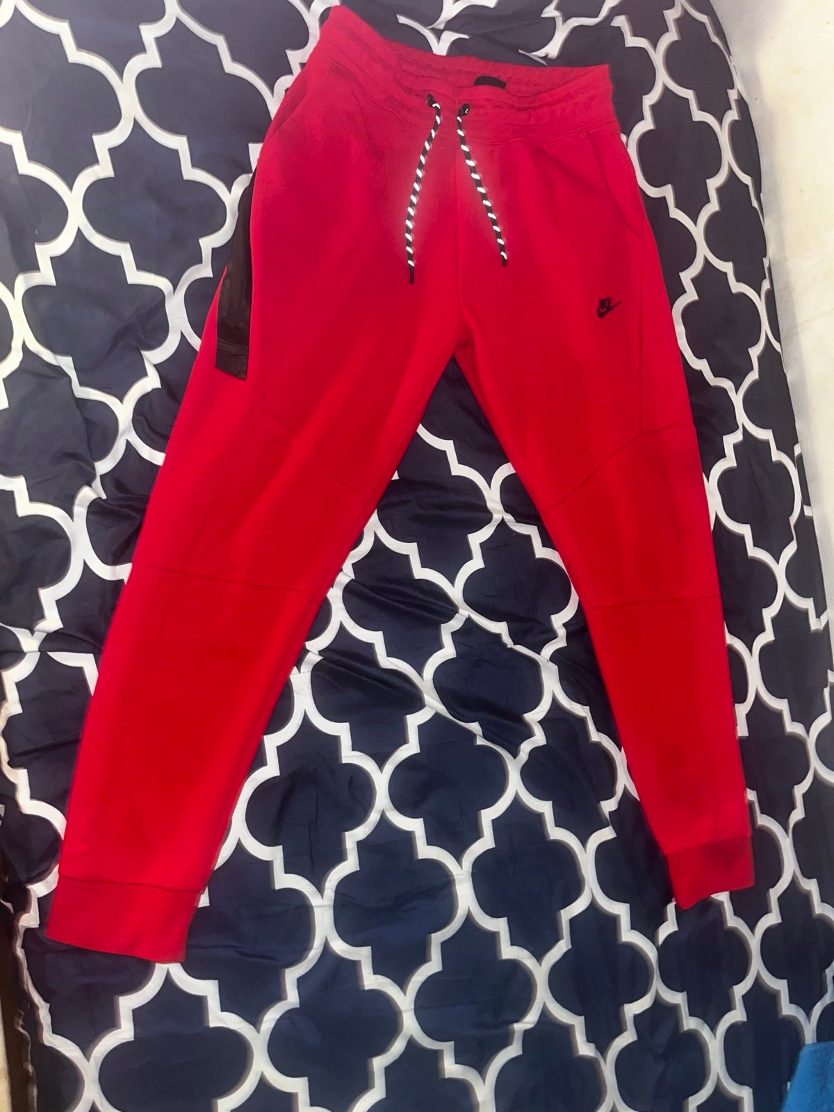 Red Nike tech bottoms