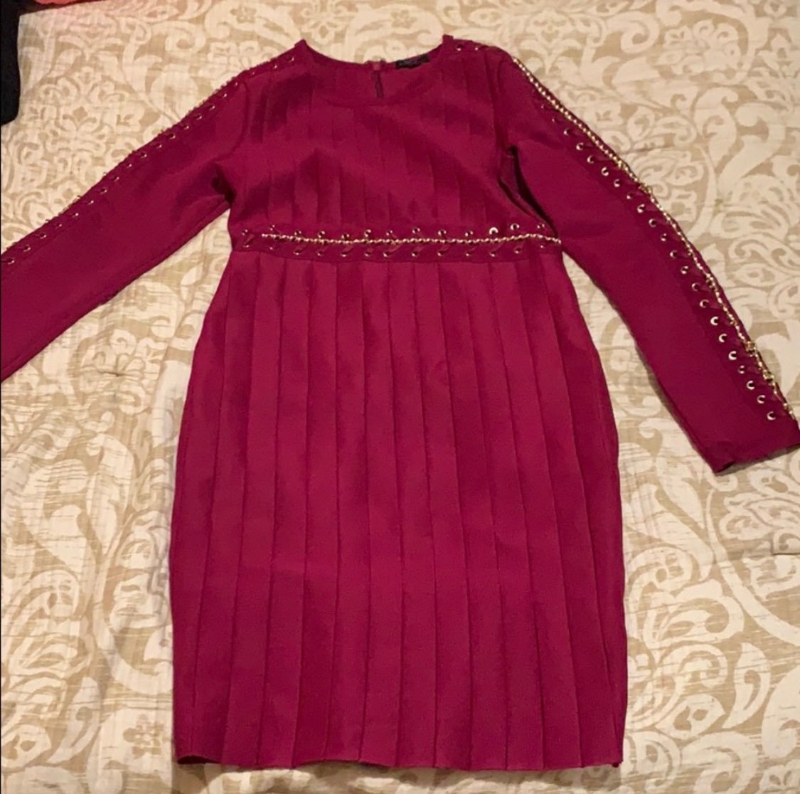 Burgundy and gold dress comes down to kn