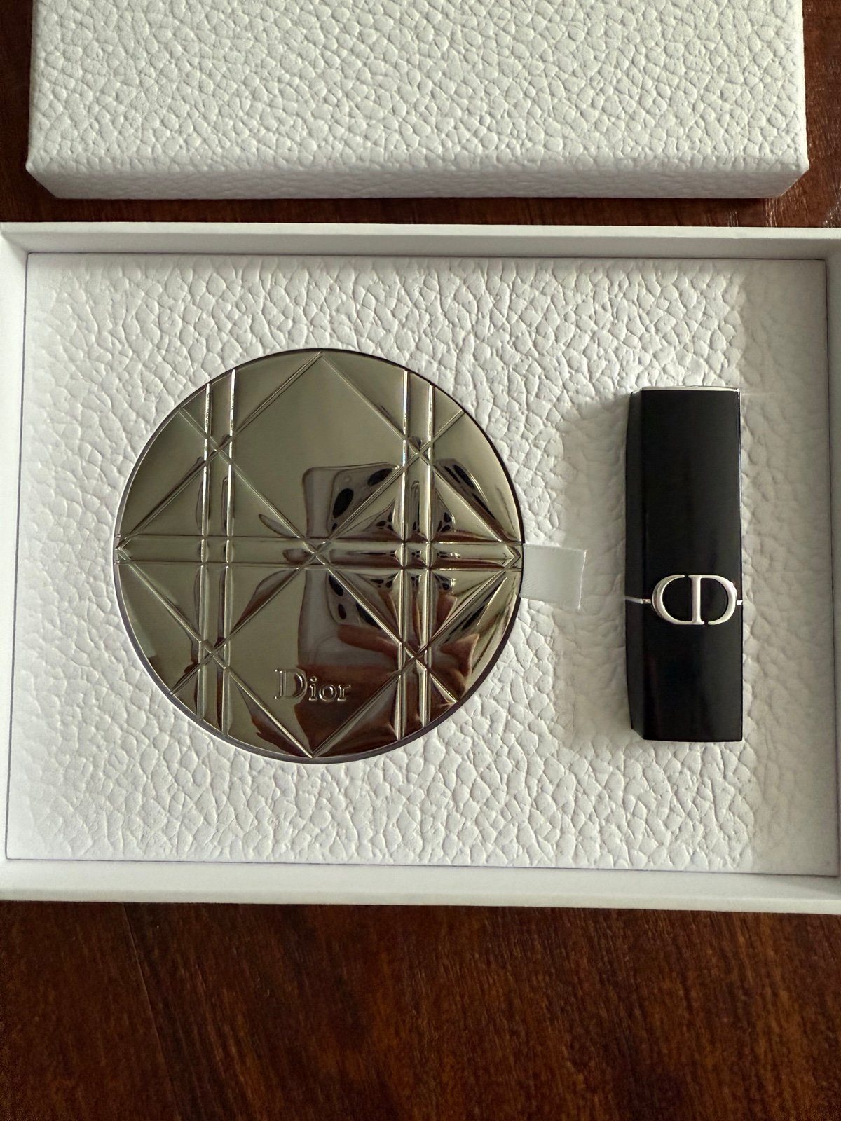 New Dior powder puffs, compact mirror, and lipstick