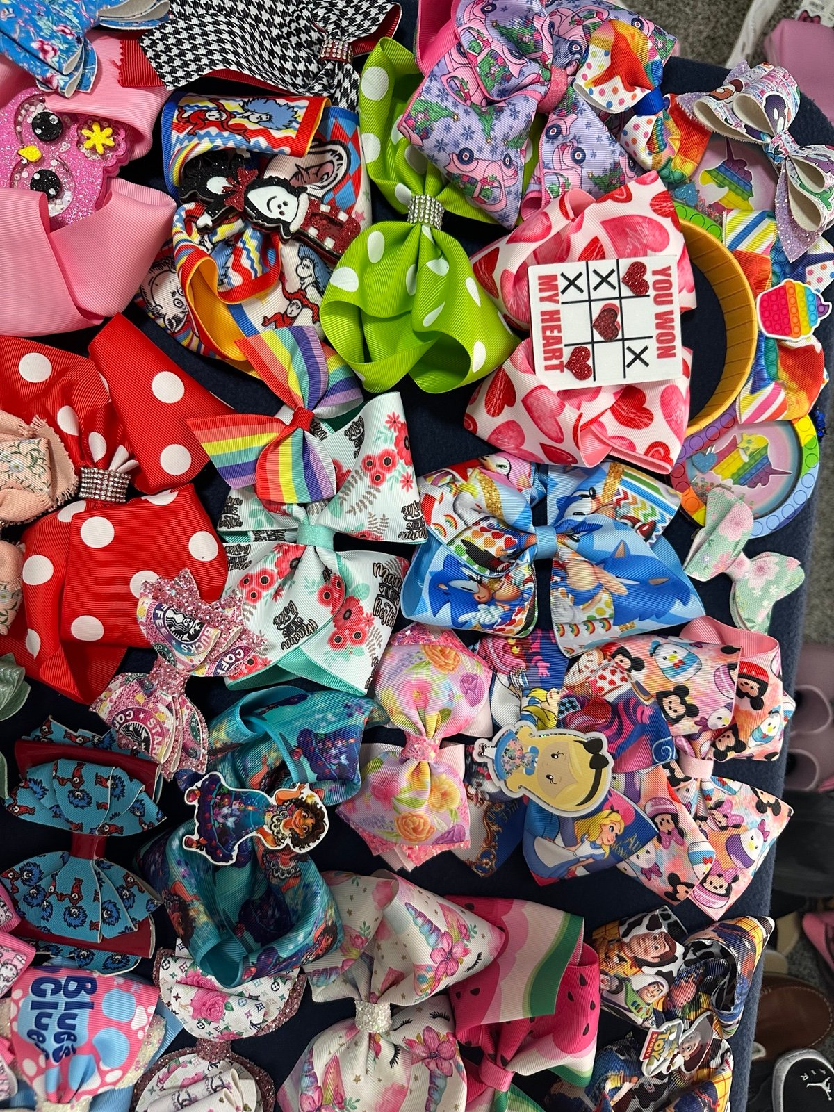 59 bows and 1 pop it headband