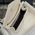 Leather envelope wrapped in white gLeather envelope wrapped in white gold buckle