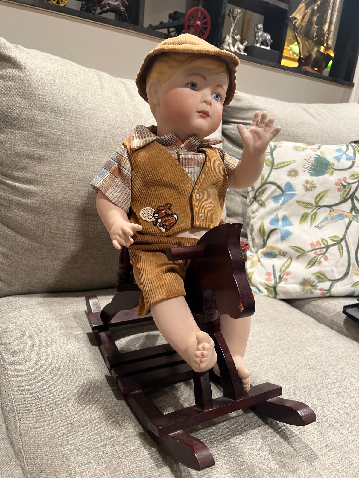 Vintage porceline doll on a rocking wooden horse