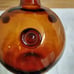 Vtg. amber art glass bottle; nodules/rigaree trim; handmade.