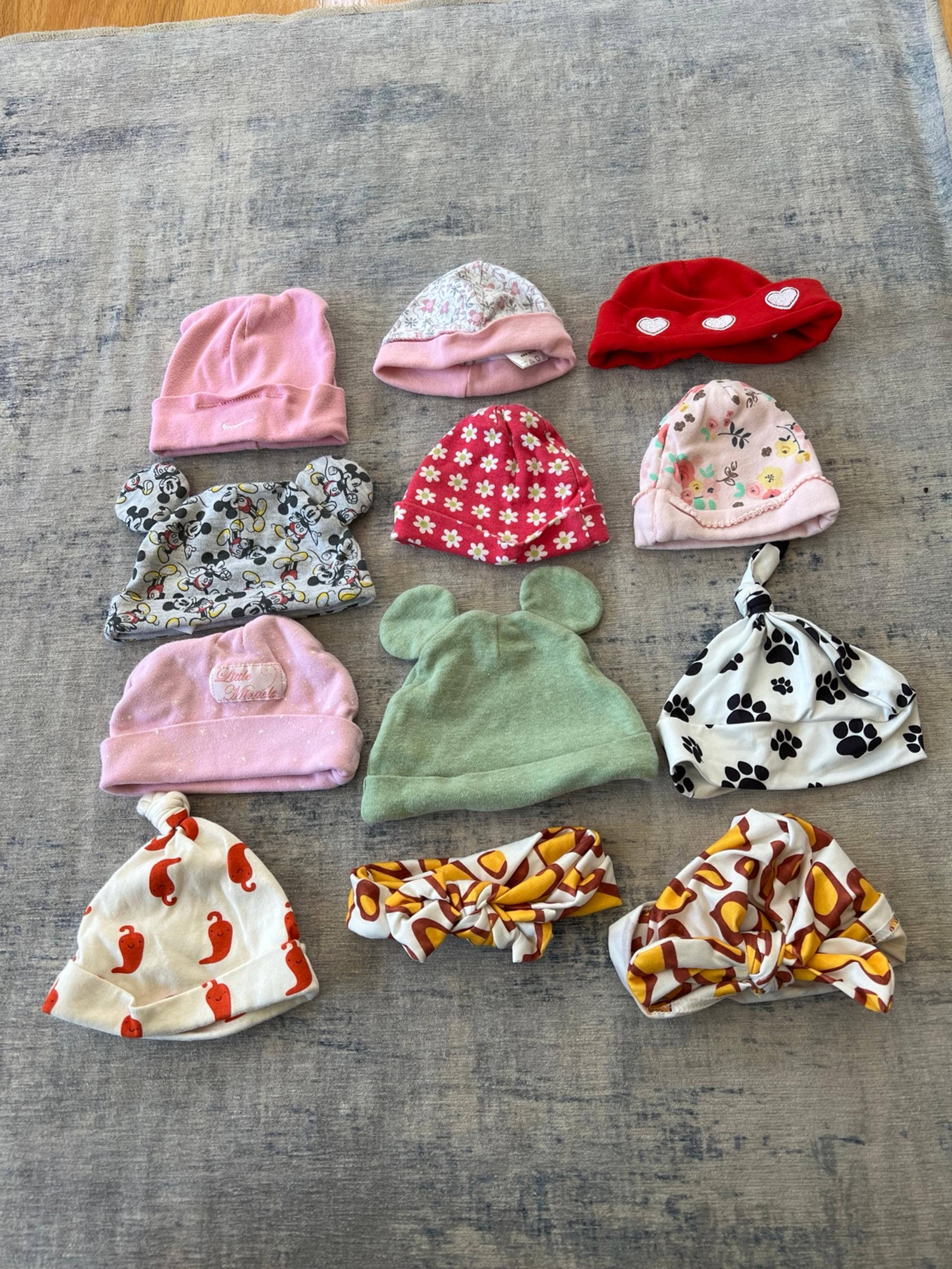 12 piece baby hat bundle, sizes between 0-6 months. Mickey, flowers, nike, etc