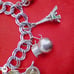 Vtg Sterling Silver Double Linked Charm Bracelet with 9 Sterling Silver Charms.