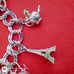 Vtg Sterling Silver Double Linked Charm Bracelet with 9 Sterling Silver Charms.