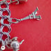 Vtg Sterling Silver Double Linked Charm Bracelet with 9 Sterling Silver Charms.