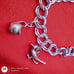 Vtg Sterling Silver Double Linked Charm Bracelet with 9 Sterling Silver Charms.