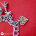 Vtg Sterling Silver Double Linked Charm Bracelet with 9 Sterling Silver Charms.