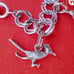 Vtg Sterling Silver Double Linked Charm Bracelet with 9 Sterling Silver Charms.